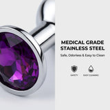 Close-up of metallic silver pleasure products decorated with large round colorful faux diamonds