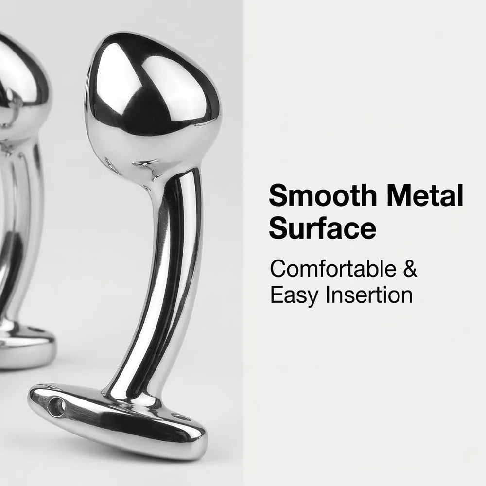 Close-up of three polished metal adult toys with t-bar bases containing small holes