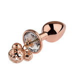 Close-up of smooth, tapered metal wellness accessories in a luxury rose gold finish with rhinestone bases