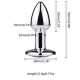 Three teardrop-shaped metal wellness tools with reflective silver surfaces and jewel embellishments