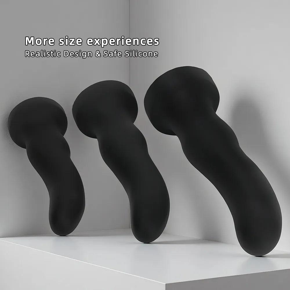 Side profile of three black silicone anal plugs showcasing their ergonomic curve for targeted stimulation
