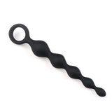 Close-up of the secure finger retrieval ring on the flexible silicone butt plug for easy removal