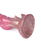 A studio portrait of a multi-colored pastel pink fantasy dildo with an organic textured stem and a solid suction cup base