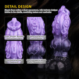 A studio portrait of a bi-color iridescent fantasy dragon toy with a ribbed stem and a solid black sculpt base