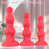 Full-length view of a 9-inch red silicone pleasure toy, highlighting its smooth finish and distinct, anatomically-inspired knot structure