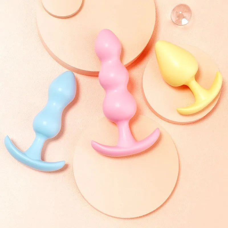 Three-piece set of smooth pastel-colored body massagers with secure bases