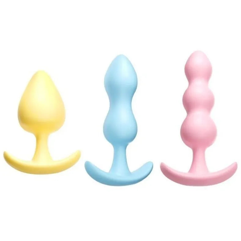 Set of three cute pastel-colored silicone butt plugs with flared bases