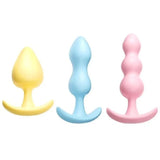 Set of three cute pastel-colored silicone butt plugs with flared bases