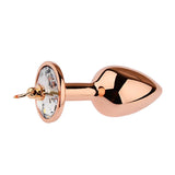 Three sizes of metallic rose gold anal toys featuring a sparkling diamond-like gemstone at the bottom